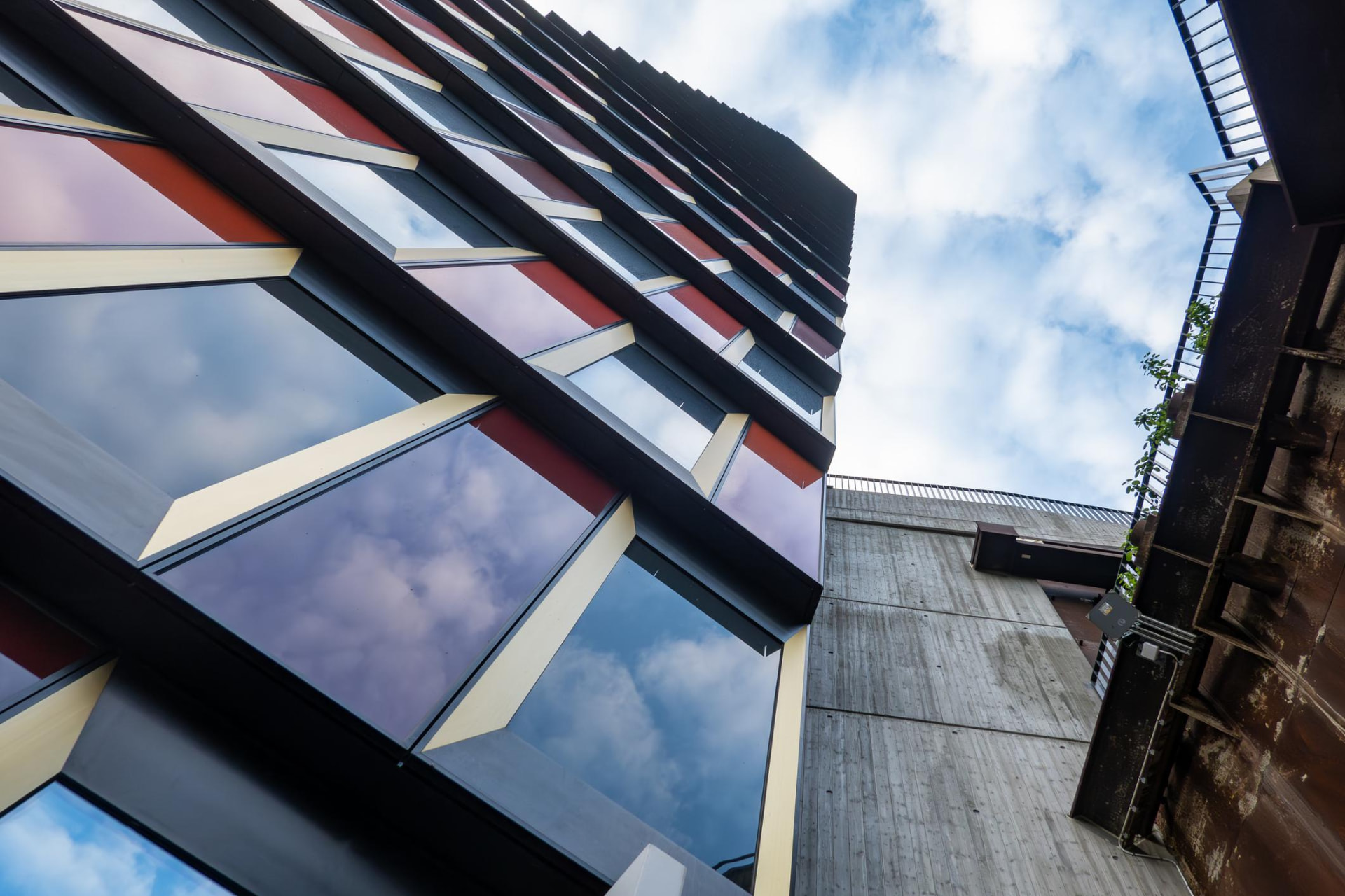 Modern facade with repeating diagonal windows and strong structural lines